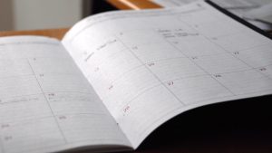 Open monthly planner on wooden desk