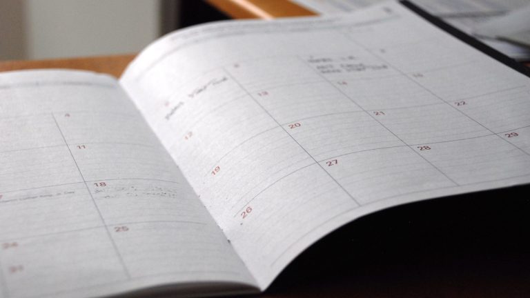 Open monthly planner on wooden desk